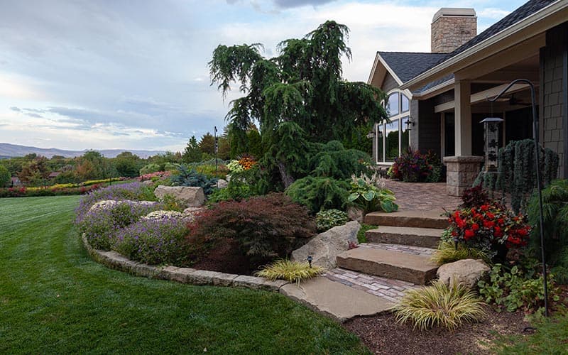 Layered flowering landscape, stone steps, and lawn at a Franz Witte residential project