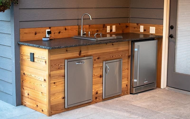 Compact custom cedar outdoor kitchen built by Franz Witte